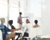 Defocused shot of a group of businesspeople having a meeting in an office